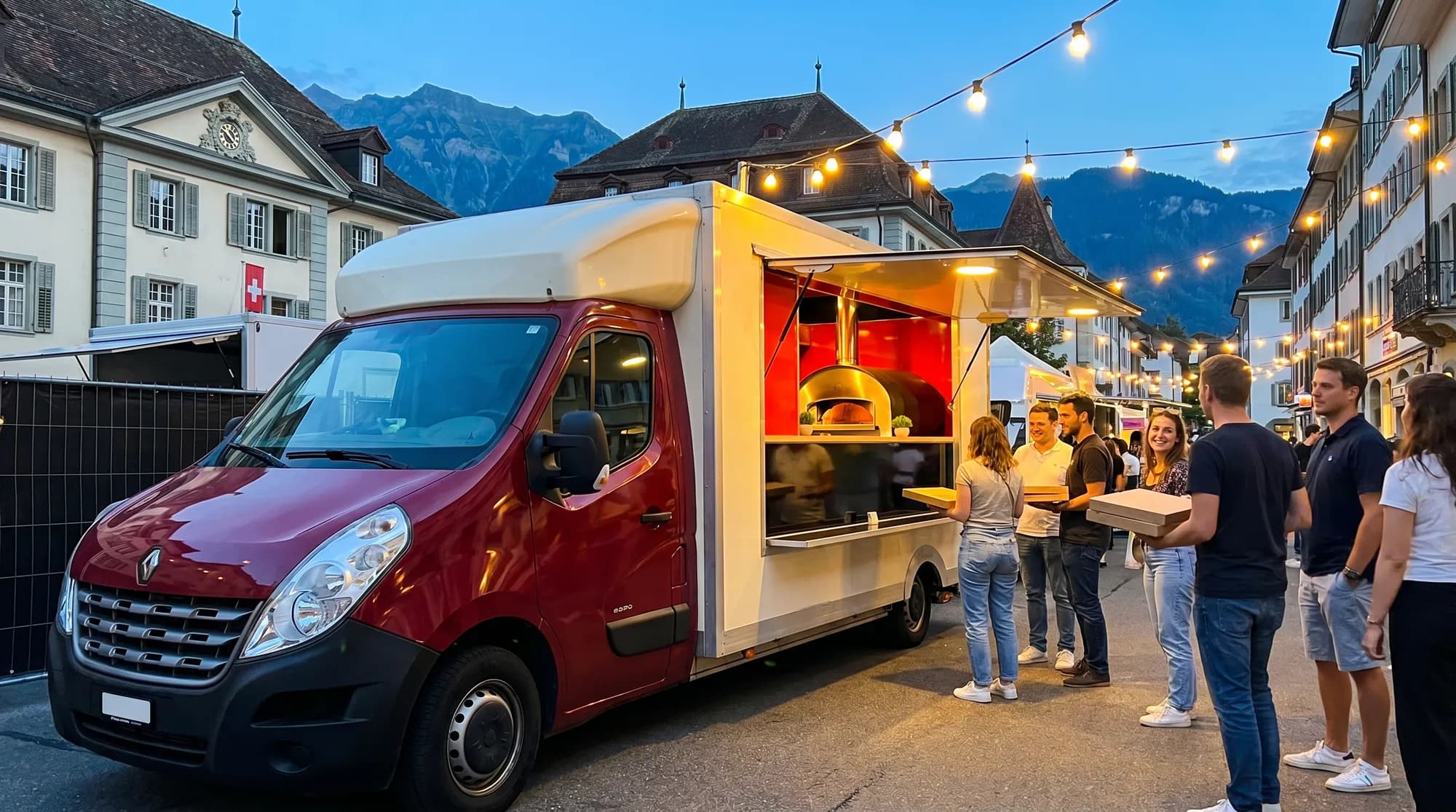 Camion pizza four à gaz lors d'un festival de street food en soirée en Suisse