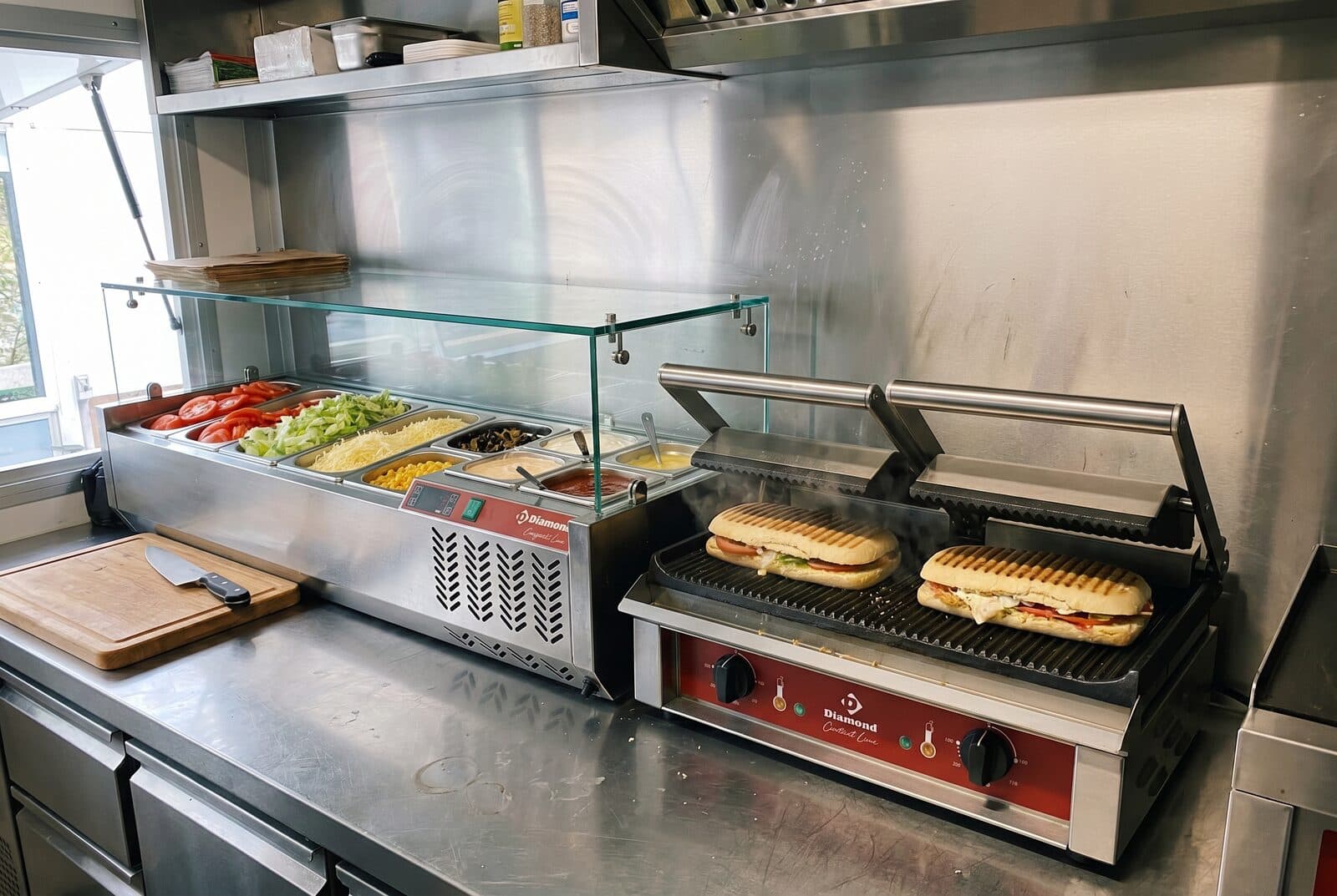 Refrigerated prep unit and contact grill in the preparation zone of a food truck